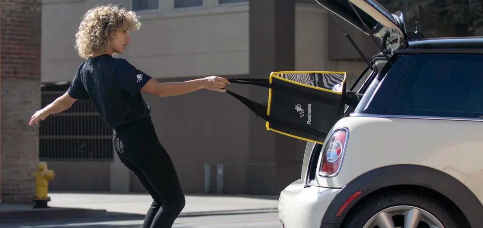 A Postmate courier making a delivery